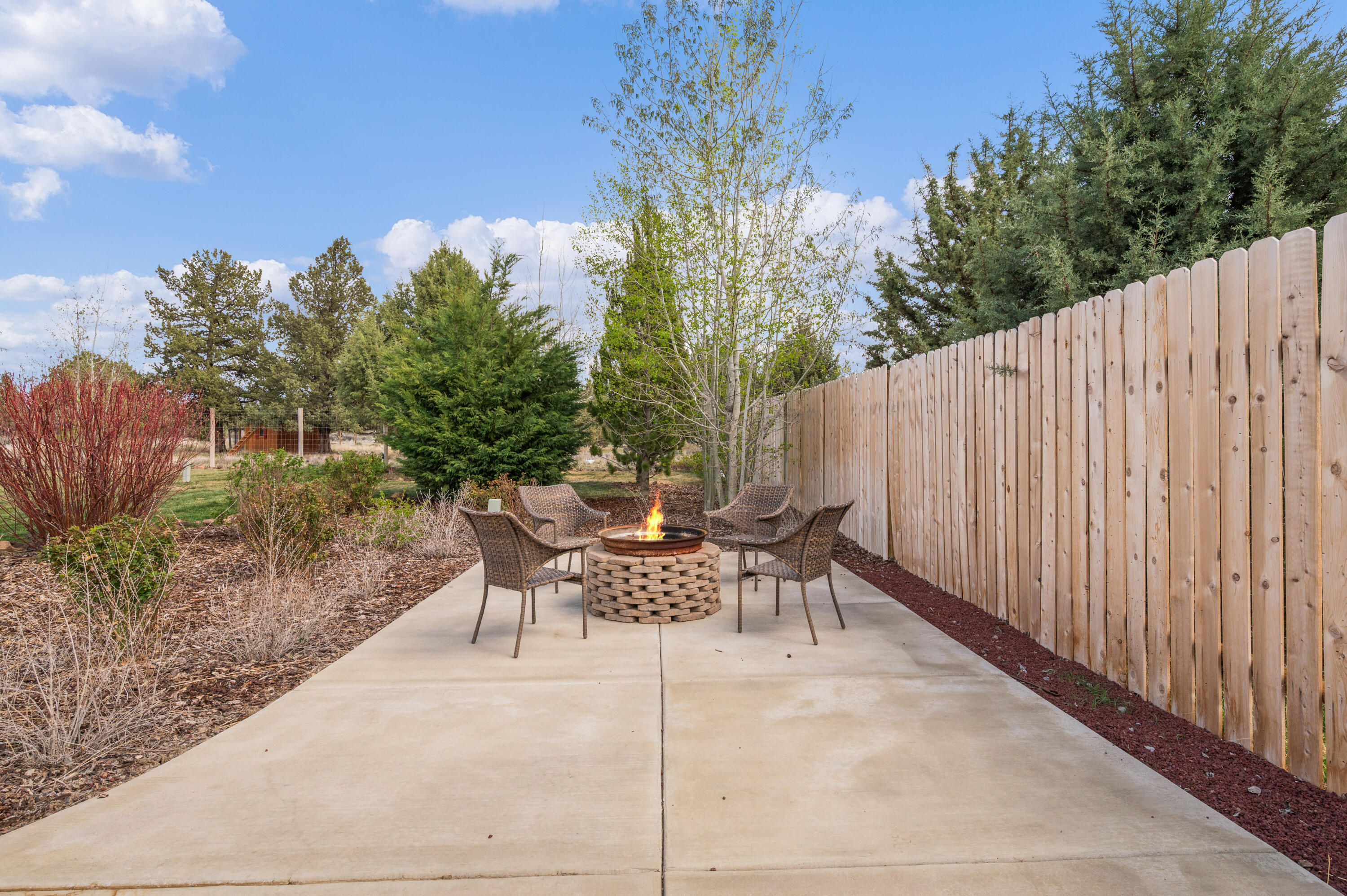 16625 Southwest Dove Road Terrebonne, OR 97760 - Photo 38 of 50 a view of a patio with table and chairs and potted plants with wooden floor and fence