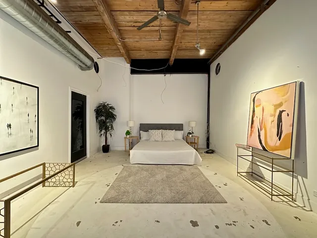 a room with painting on the wall and table