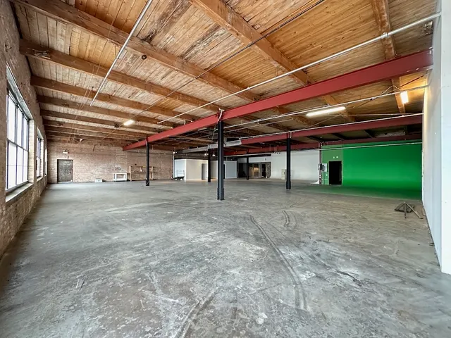 a view of a big room with a fridge
