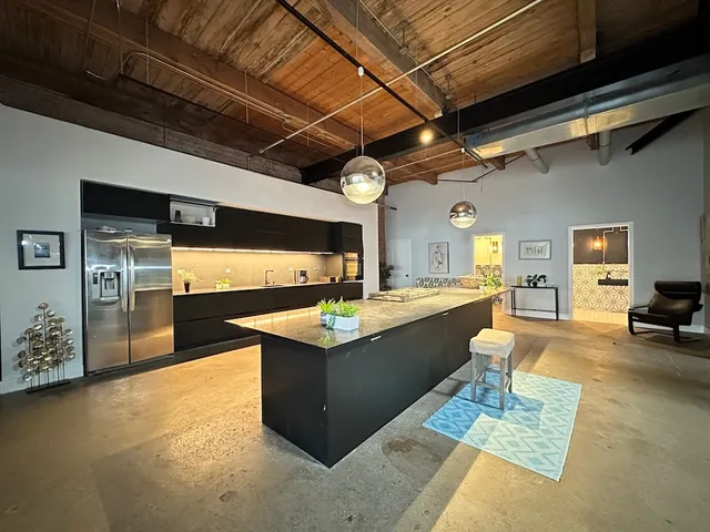 a view of living room with granite countertop furniture and a kitchen