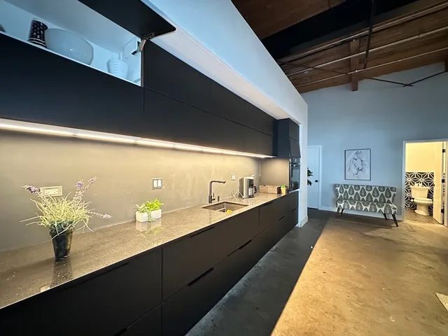a kitchen with stainless steel appliances a sink dishwasher and white cabinets