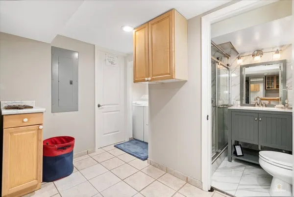 a bathroom with a sink toilet and shower