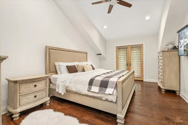 a spacious bedroom with a bed and a dresser
