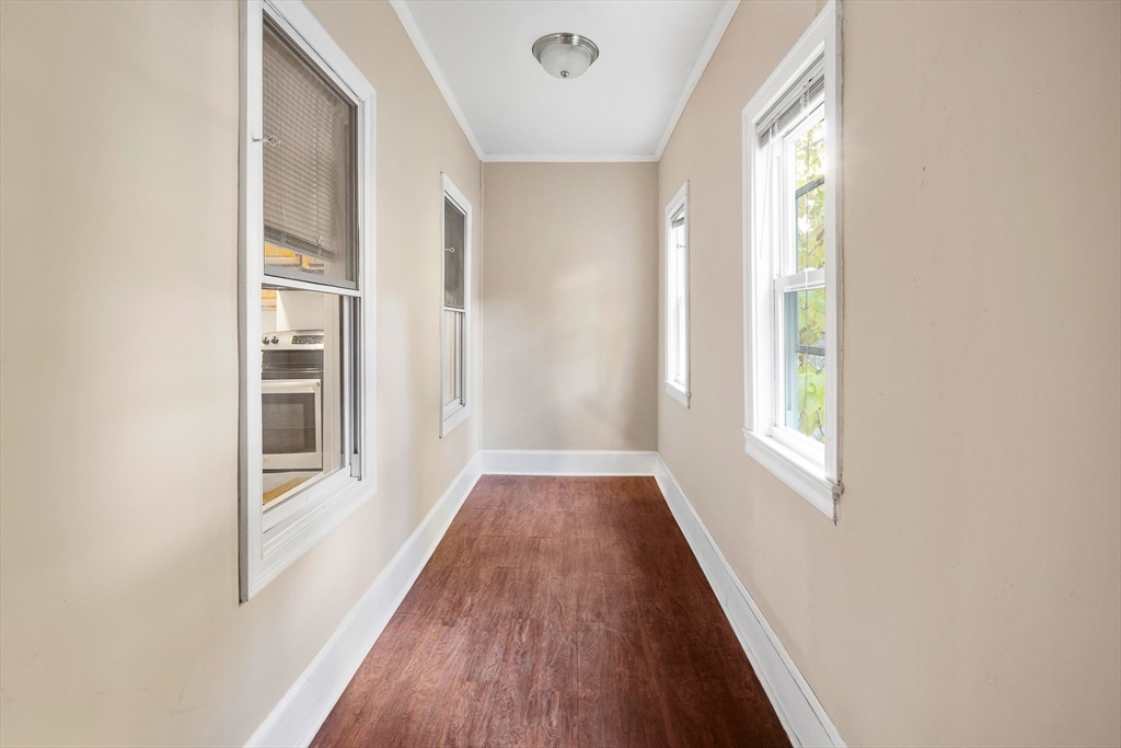 53 Copeland Street, Unit 2 Boston, MA 02119 - Photo 12 of 15 a view of a hallway with wooden floor and windows