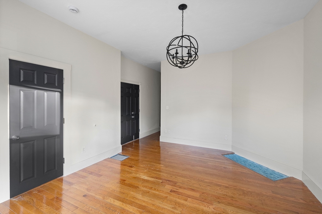 53 Copeland Street, Unit 2 Boston, MA 02119 - Photo 14 of 15 a view of a hallway with wooden floor and a window