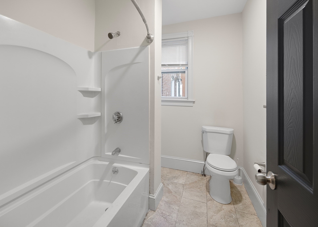 53 Copeland Street, Unit 2 Boston, MA 02119 - Photo 7 of 15 a white toilet sitting next to a bath tub