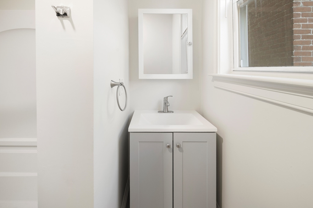 53 Copeland Street, Unit 2 Boston, MA 02119 - Photo 8 of 15 a bathroom with a sink and a vanity