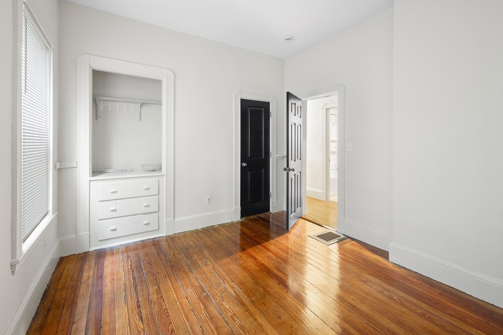 53 Copeland Street, Unit 2 Boston, MA 02119 - Photo 9 of 15 an empty room with cabinet and mirror