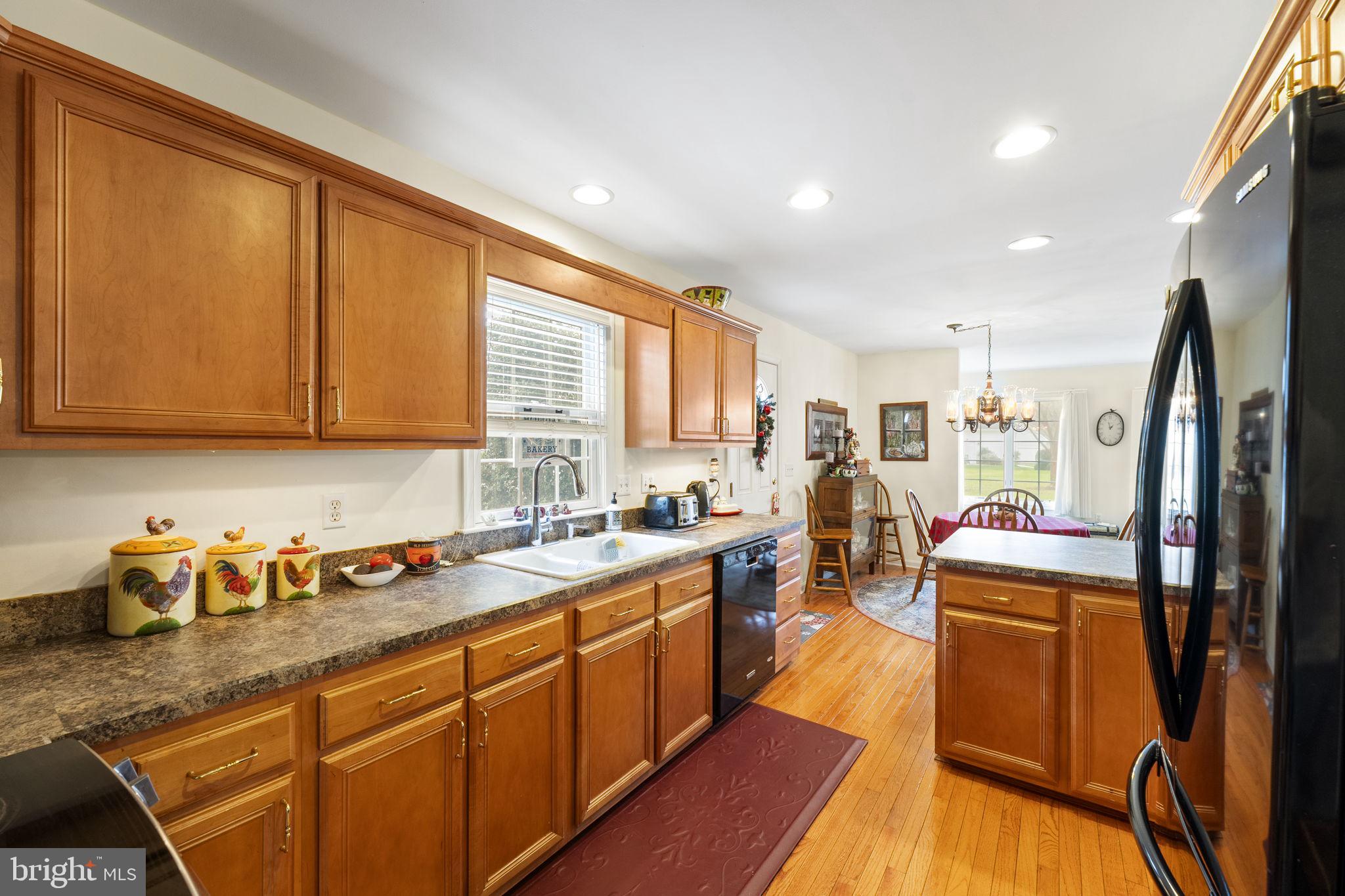 212 Spring Crest Drive Salisbury, MD 21804 - Photo 16 of 42 a kitchen with lots of counter top space and wooden floor