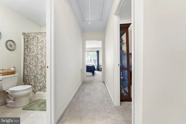 a view of a bathroom with toilet and shower