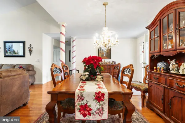 a view of a dining room with furniture and chandelier