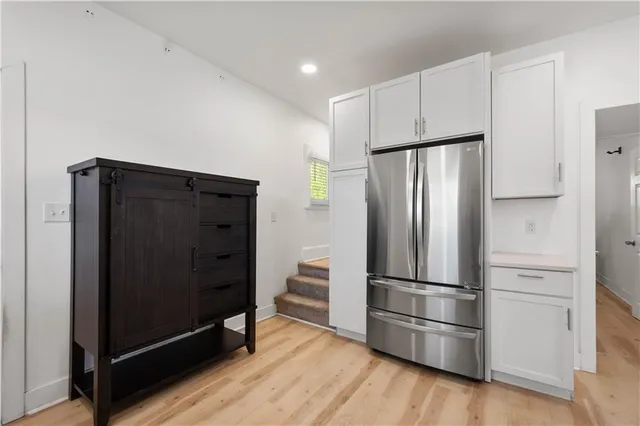 a metallic refrigerator freezer sitting in a kitchen