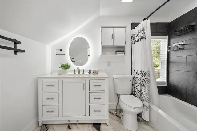 a bathroom with a toilet a sink and a bathtub