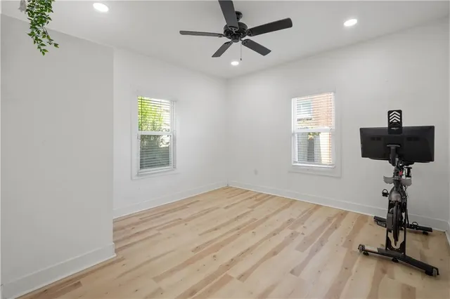 a view of empty room with a window and wooden floor