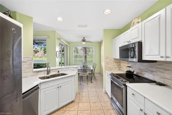 a spacious bathroom with a granite countertop sink a mirror and a shower