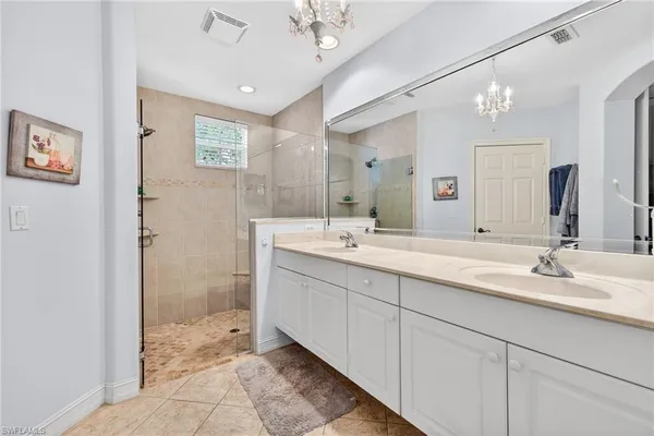 a bathroom with a double vanity sink and a mirror