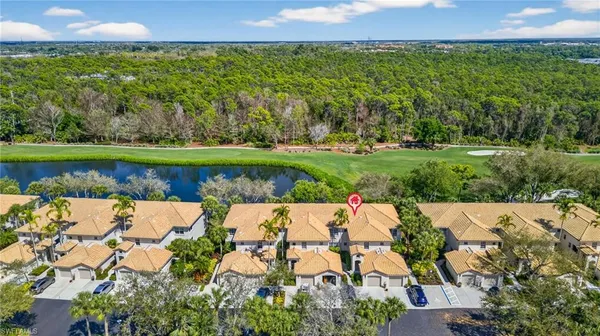 an aerial view of residential houses with outdoor space and swimming pool