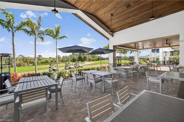 a view of a patio with dining table and chairs