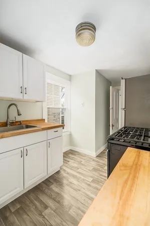 a kitchen with a sink stove and cabinets