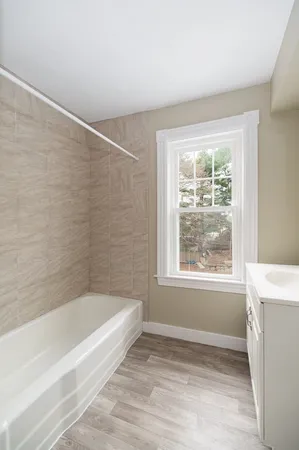 a bathroom with a bathtub and window