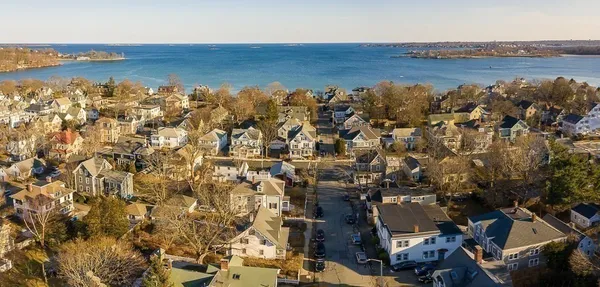 an aerial view of residential building and ocean