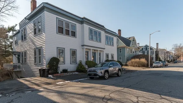 a view of a car park in front of house