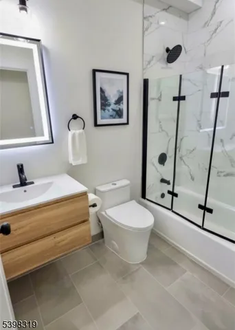 a bathroom with a toilet sink and a mirror