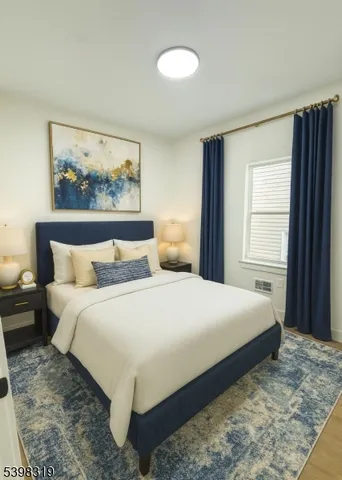 a bedroom with a large bed and a window