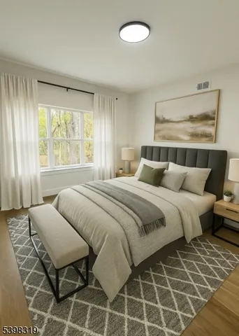 a bedroom with a large bed and a window