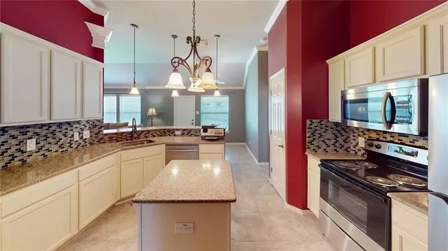 a kitchen with a stove a sink and a refrigerator