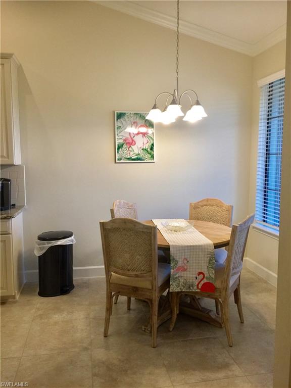 9426 Benvenuto Court, Unit 203 Naples, FL 34119 - Photo 10 of 42 a view of a dining room with furniture