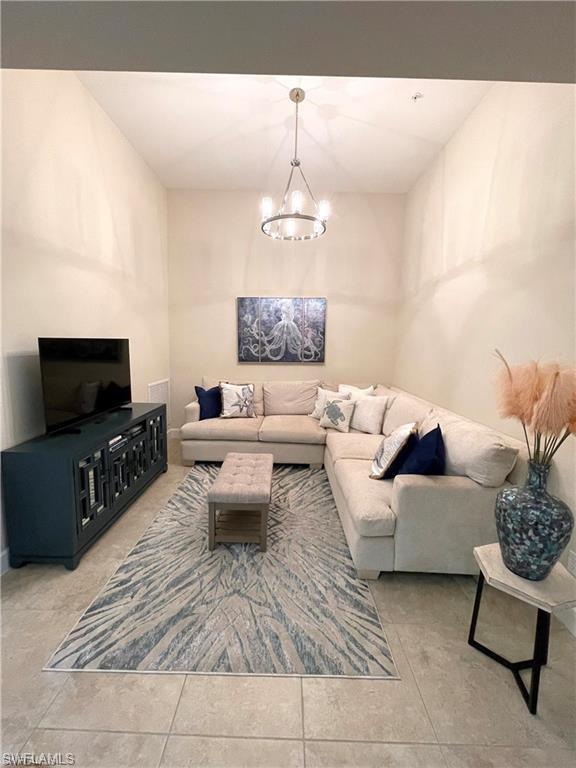 9426 Benvenuto Court, Unit 203 Naples, FL 34119 - Photo 11 of 42 a living room with furniture and a flat screen tv