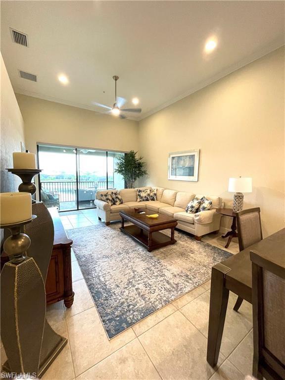 9426 Benvenuto Court, Unit 203 Naples, FL 34119 - Photo 14 of 42 a living room with furniture and a large window