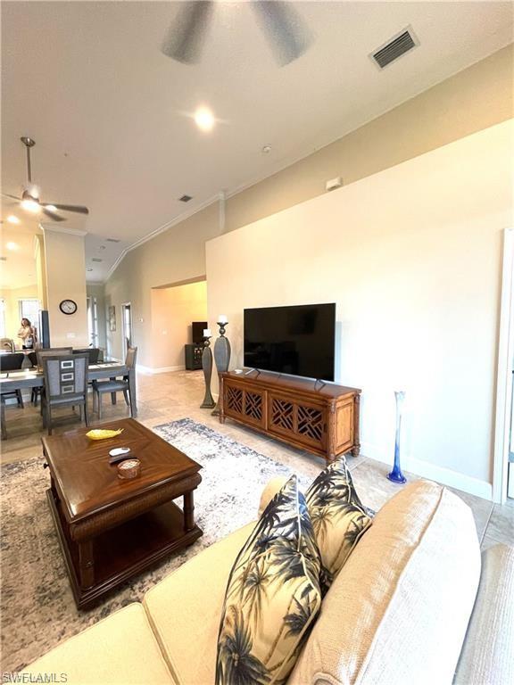 9426 Benvenuto Court, Unit 203 Naples, FL 34119 - Photo 17 of 42 a living room with furniture and a flat screen tv