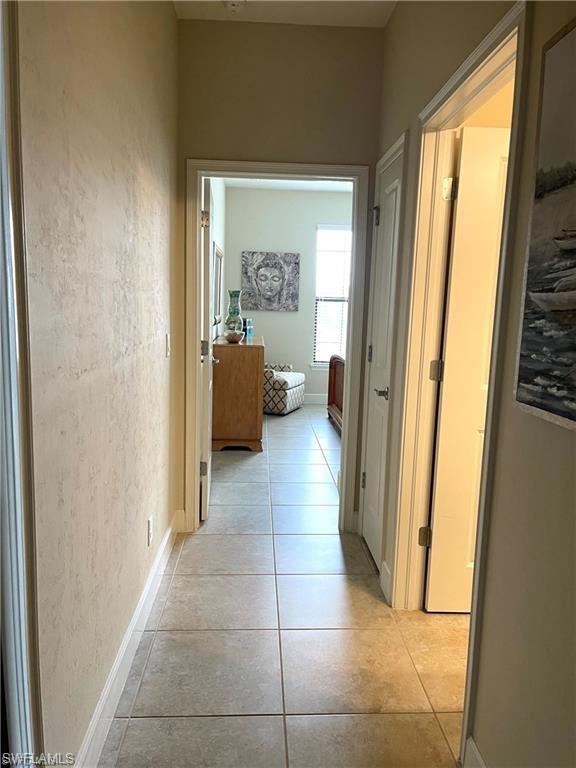 9426 Benvenuto Court, Unit 203 Naples, FL 34119 - Photo 24 of 42 a view of hallway with furniture and a gate