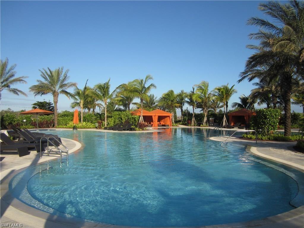 9426 Benvenuto Court, Unit 203 Naples, FL 34119 - Photo 37 of 42 swimming pool view with a garden space