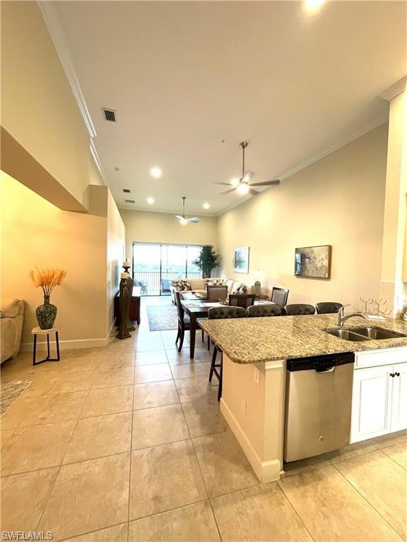 9426 Benvenuto Court, Unit 203 Naples, FL 34119 - Photo 42 of 42 a dining hall with stainless steel appliances kitchen island granite countertop a sink and cabinets