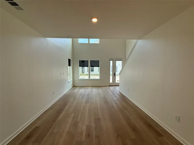 a view of kitchen with refrigerator microwave and wooden floor