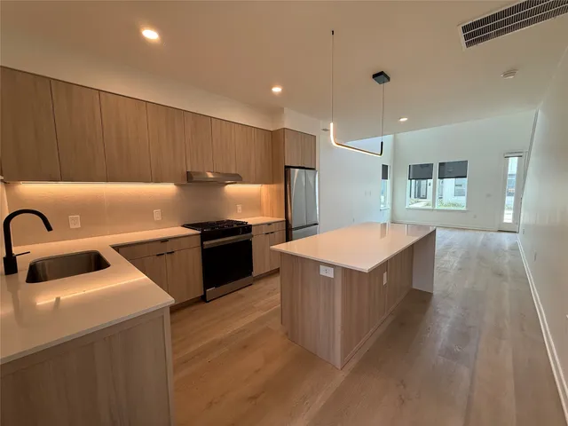 a kitchen with a stove and a refrigerator