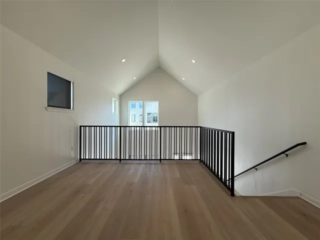 a view of staircase with wooden floor and windows