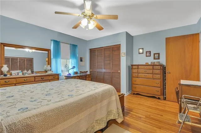 a spacious bedroom with a bed and a view of living room