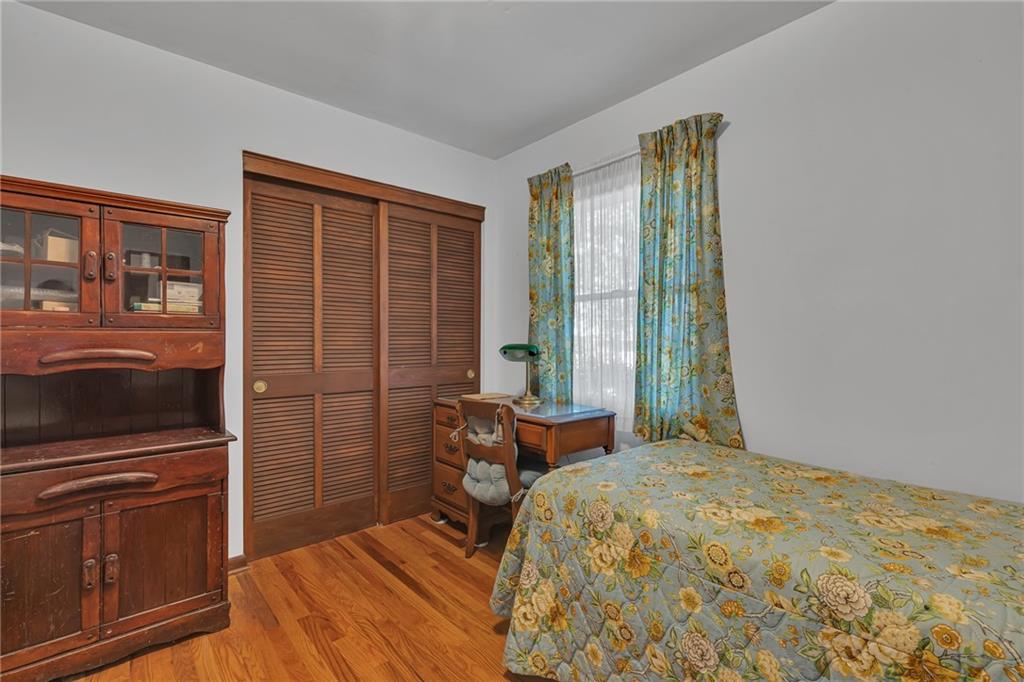 111 Truman Street Monaca, PA 15061 - Photo 14 of 23 a bedroom with a bed and wooden floor