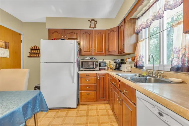 a kitchen with a refrigerator and a sink