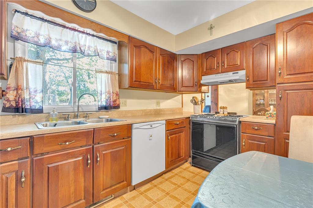 111 Truman Street Monaca, PA 15061 - Photo 4 of 23 a kitchen with granite countertop a sink stainless steel appliances and cabinets