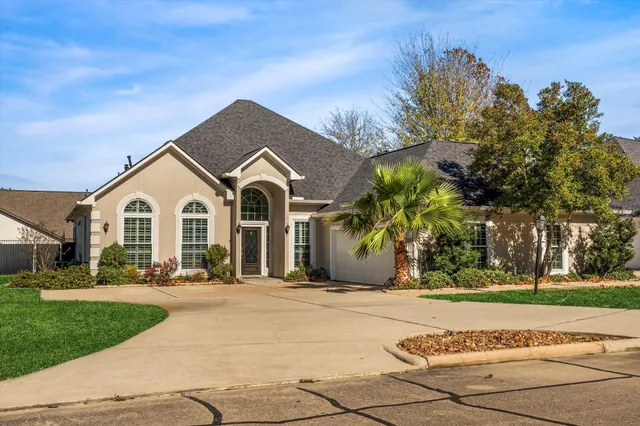 a view of a white house with a yard