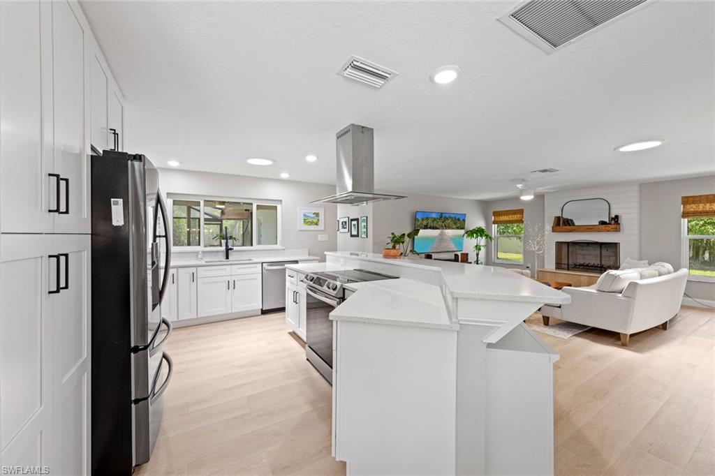 3795 Liberty Square Fort Myers, FL 33908 - Photo 12 of 43 a living room with furniture and a kitchen view
