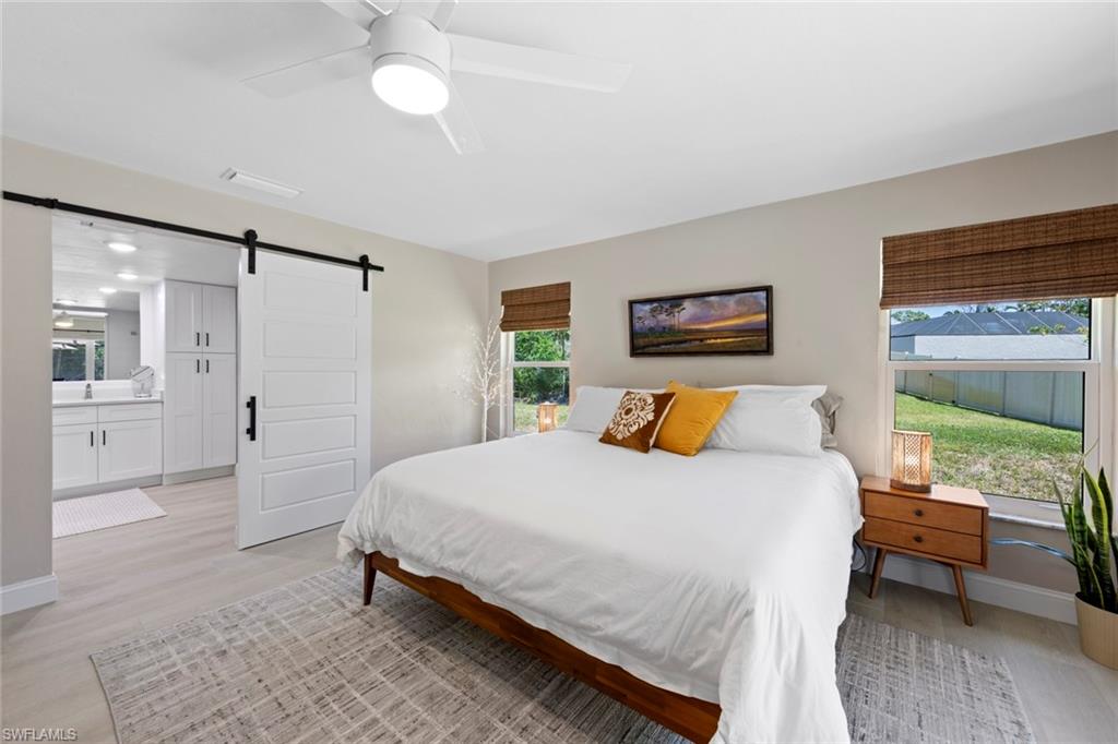 3795 Liberty Square Fort Myers, FL 33908 - Photo 23 of 43 a bedroom with a bed and a chandelier