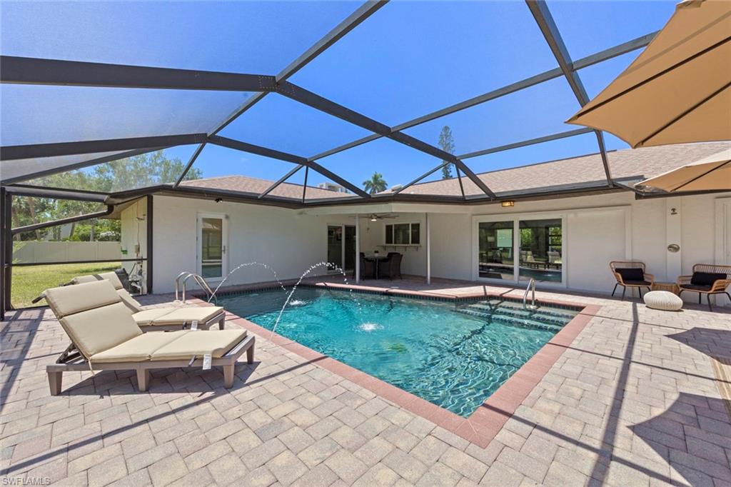 3795 Liberty Square Fort Myers, FL 33908 - Photo 34 of 43 a view of a patio with a table and chairs under an umbrella