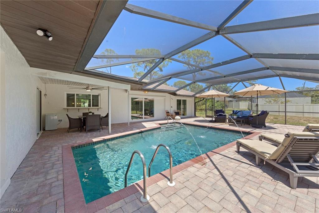 3795 Liberty Square Fort Myers, FL 33908 - Photo 36 of 43 a view of a patio with table and chairs under an umbrella