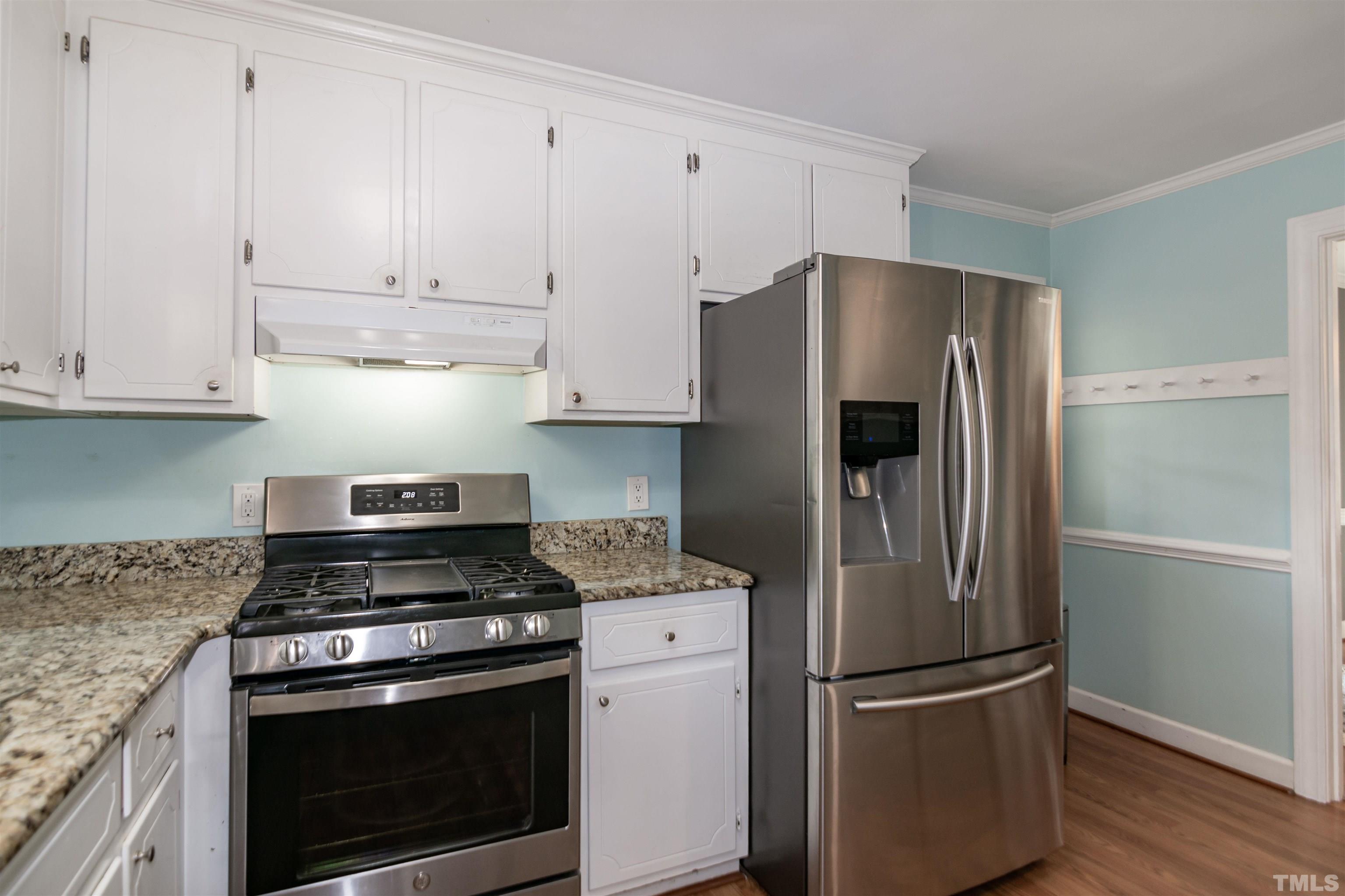 2009 Bason Court Raleigh, NC 27609 - Photo 15 of 40 a kitchen with cabinets and stainless steel appliances